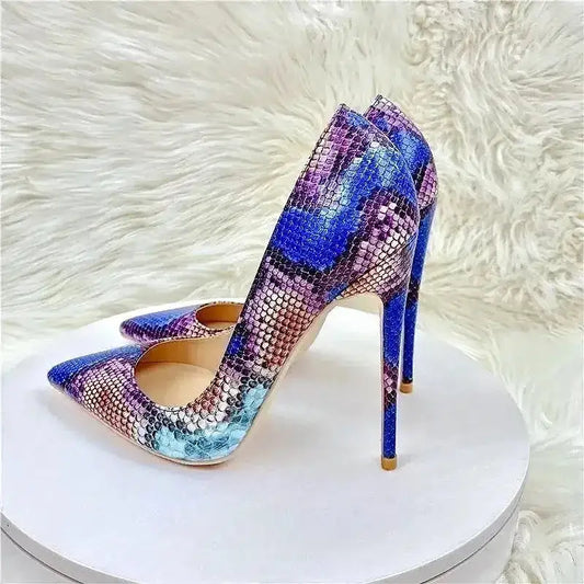 Cobalt Snake Heels - Viper Pumps with pointed toe and 12cm stiletto heel in bold blue and purple snake print, displayed on white fur.