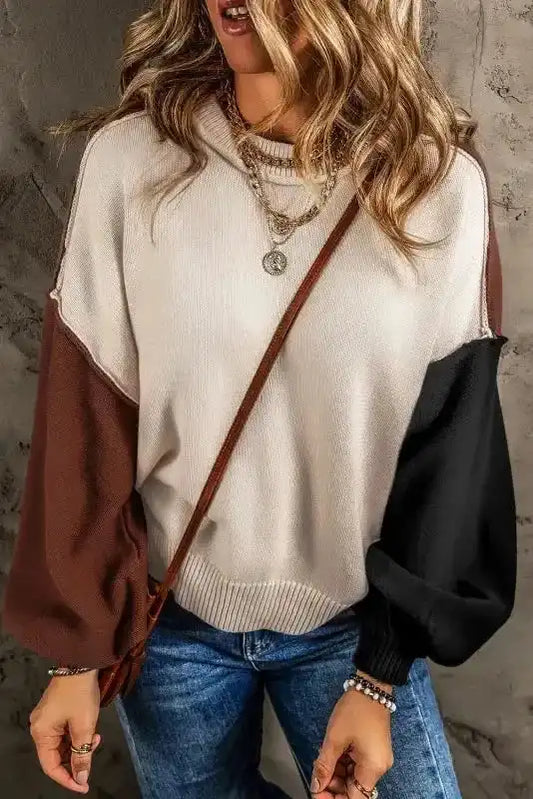 Colorblock Bishop Sleeve Sweater - Women's Sweaters at FashionFitz styled with jeans and layered necklaces. Features beige body with brown and black sleeves.