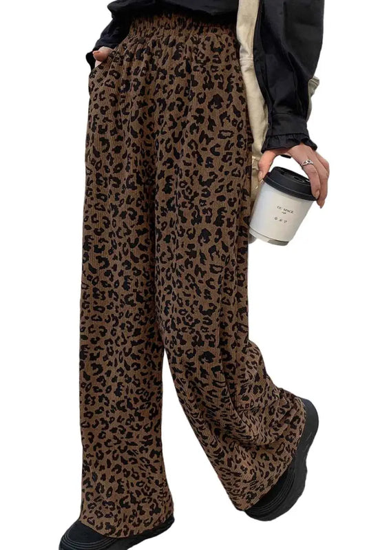 Leopard corduroy trousers women in brown with high waist and wide leg silhouette, styled casually with black top and sneakers.
