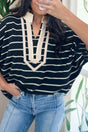 Woman wearing black stripe stand collar V-neck dolman top with elastic cuffs front view Fashionfitz UK