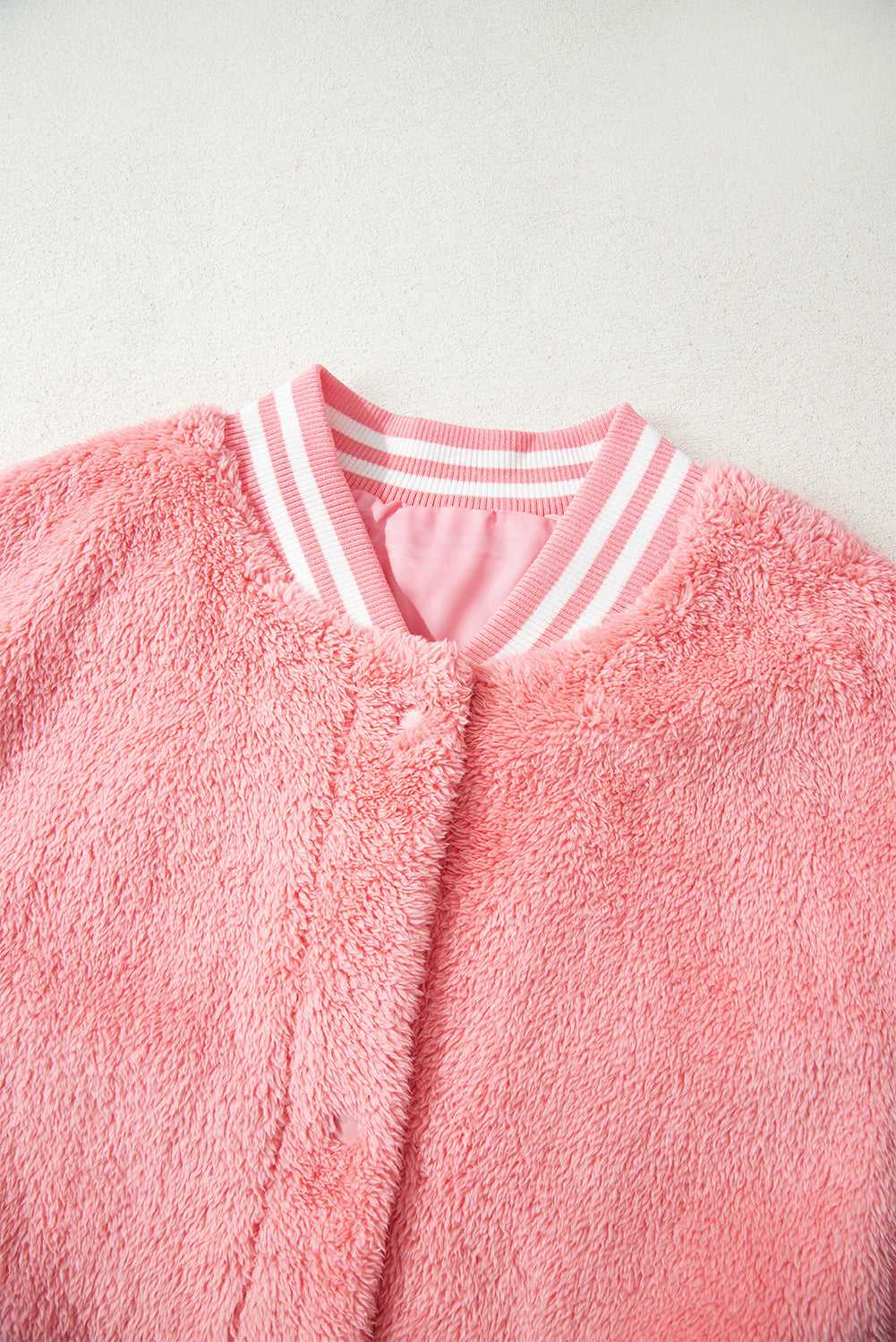 Close-up of plush sherpa texture in varsity pink