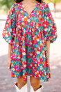 Sky blue floral babydoll dress with bubble sleeves and V-neckline, styled with white boots for a casual summer look.
