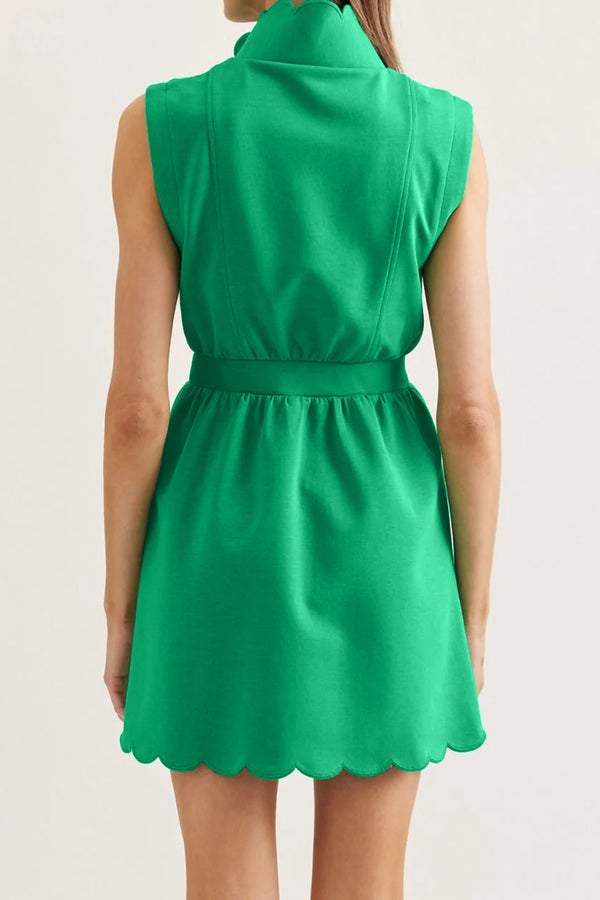 Green mini dress — scallop hem detail close-up, zip-front neckline