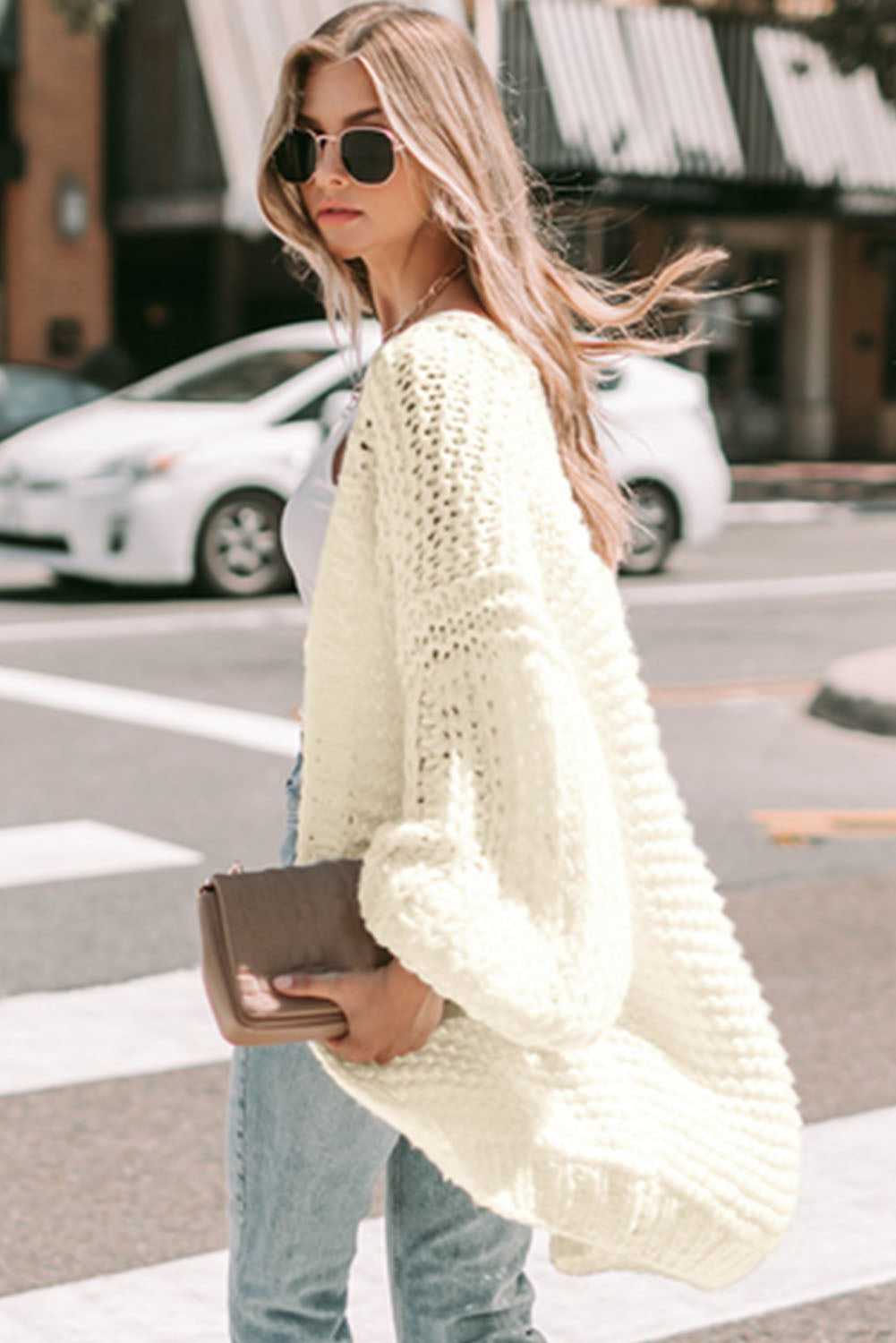Back view of oversized white chunky knit cardigan with relaxed fit, perfect for layering in cool weather.