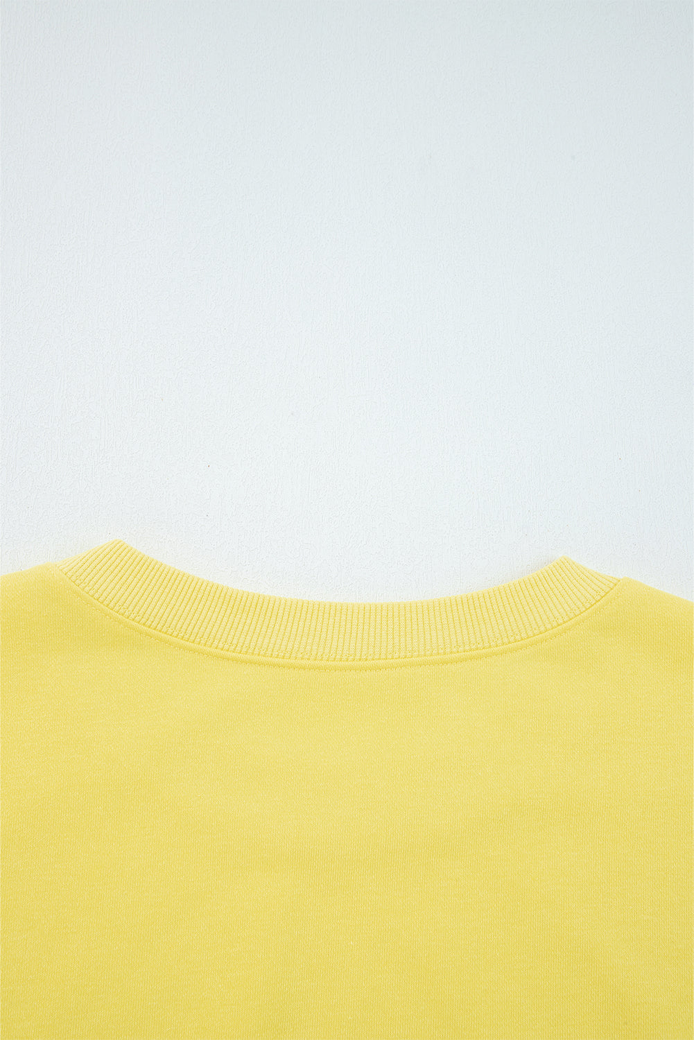 Rear neckline detail of yellow Drop Crop Wide-Leg Pants Set, showcasing ribbed collar for added comfort and durability.