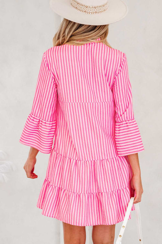 Back view of pink striped tiered flowy mini dress women