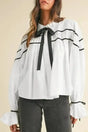 Monochrome Striped Bowtie Cotton Ruffle Blouse Women UK in white — front view showing black piping, bowtie detail and ruffled sleeves — Fashionfitz