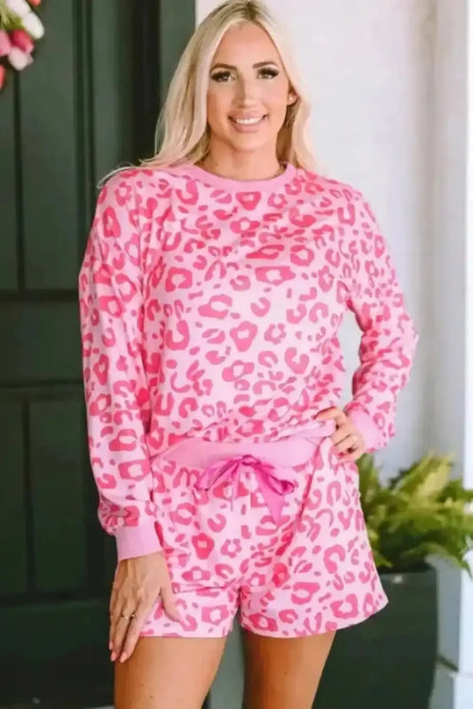 Woman wearing pink leopard satin lounge set with long sleeve top and tie shorts front view Fashionfitz UK