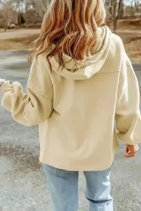 Back view of beige zip up hooded jacket women with relaxed fit and drawstring hood. Ideal casual outerwear for cool weather.