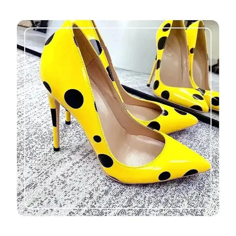 Polka Dot Yellow Stiletto High Heels Shoes displayed on carpet with mirror reflection, showcasing glossy PU leather. Elegant pumps for fashion lovers.
