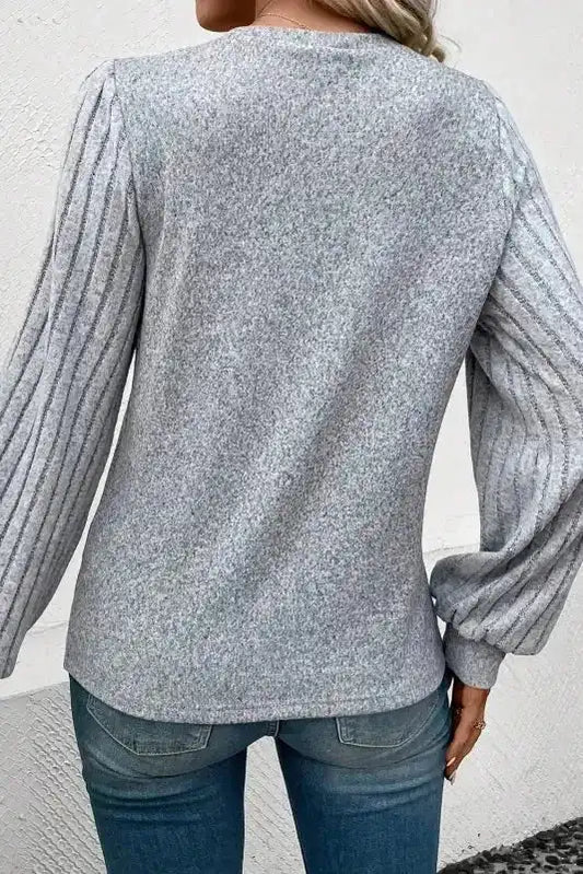 Back view of grey Ribbed Bishop Sleeve Top showcasing pleated sleeves and soft knit texture for a comfy fit.