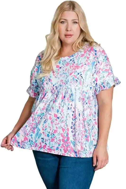 Plus size floral short sleeve top with ruffle cuffs in pink, blue, and white abstract print, ideal for casual summer wear.