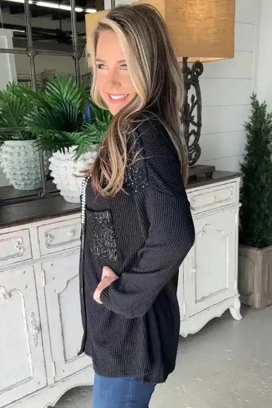 Side view of Black Sequin Patch Corded Shacket Overshirt for women, showing relaxed fit and textured ribbed fabric for winter fashion.