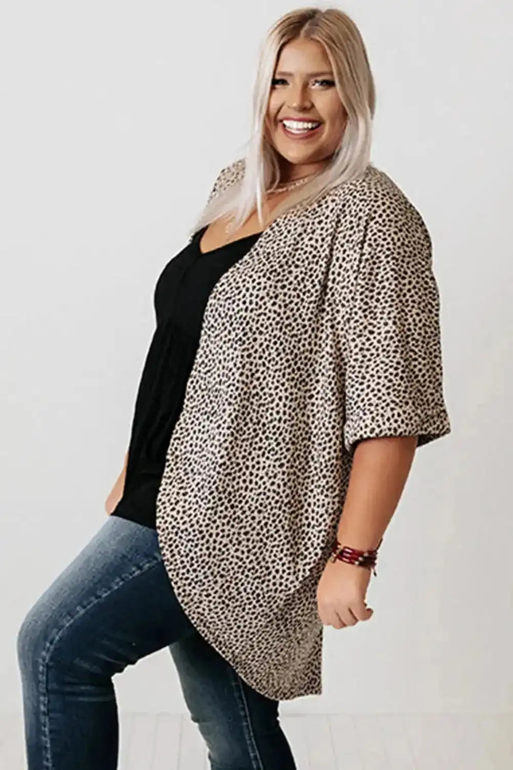 Plus size woman wearing a Khaki Leopard Print Cardigan from FashionFitz, styled with a black top and jeans. Lightweight summer cardigan with loose fit.