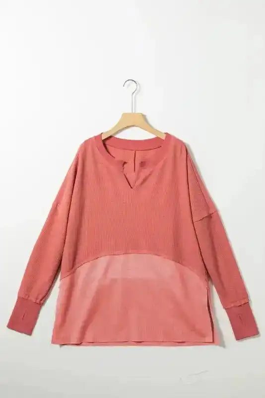 Flat lay of dusty rose Women's Exposed Seam Waffle Knit Tunic Top on hanger, highlighting its long sleeves and relaxed silhouette.