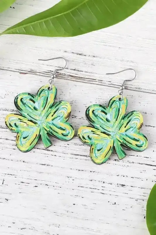 Light Green St. Patrick Painted Shamrock Shape Drop Earrings displayed on white wood with green leaves, showcasing vibrant holiday colors.