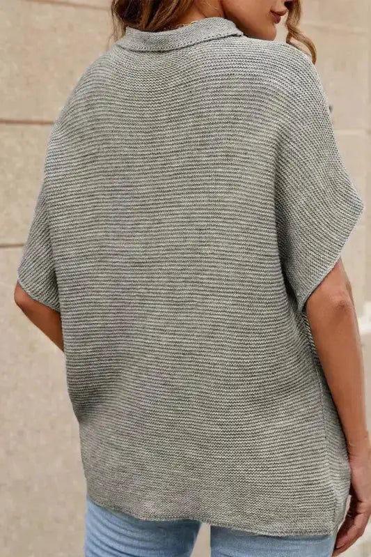Back view of grey high neck short sleeve sweater showing relaxed fit and batwing silhouette. Perfect for casual autumn wear.