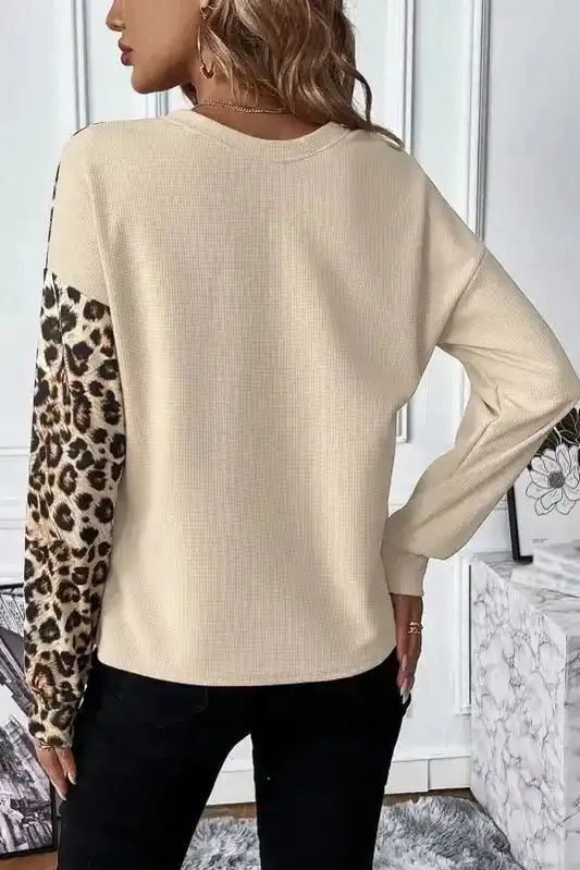 Back view of FashionFitz Khaki Leopard Colour‑block Waffle Knit Top showing solid khaki fabric with leopard print sleeve detail.