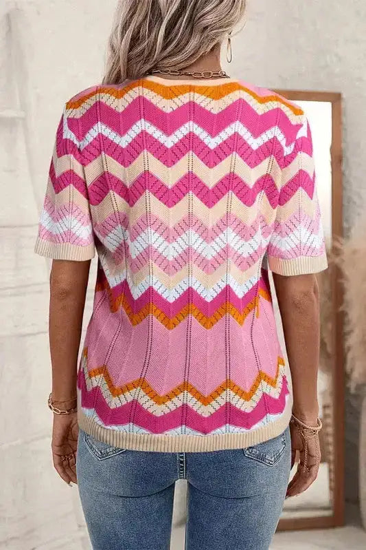 Back view of women's pink chevron crochet jumper featuring short sleeves and multicolor zigzag pattern. Perfect for casual summer outfits.