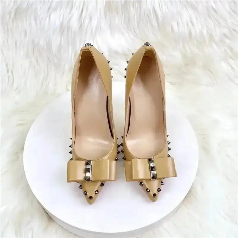 Top view of beige Riviera Bow Court Heels with bow and studded accents, perfect for elegant and modern high heel style.