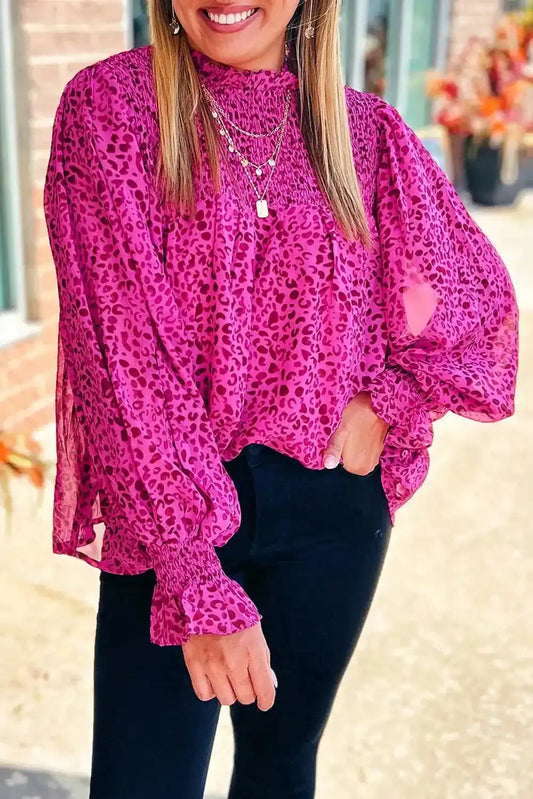 Rose Leopard Shirred Blouse with puff sleeves and flowy fit in vibrant pink leopard print, styled with black pants for a chic daily look.