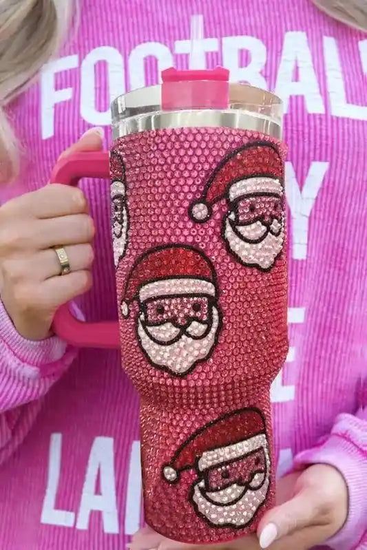 Rose red Santa Claus thermos cup with festive diamond design and straw, held by woman in pink sweater, perfect for holiday beverages.