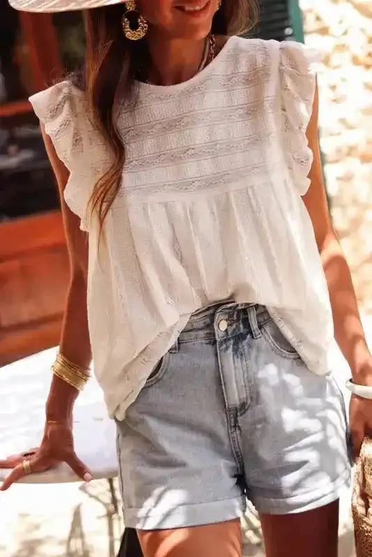 White Ruffled Lace Flowy Tank Top styled with denim shorts, perfect for summer casual wear and feminine layering looks.