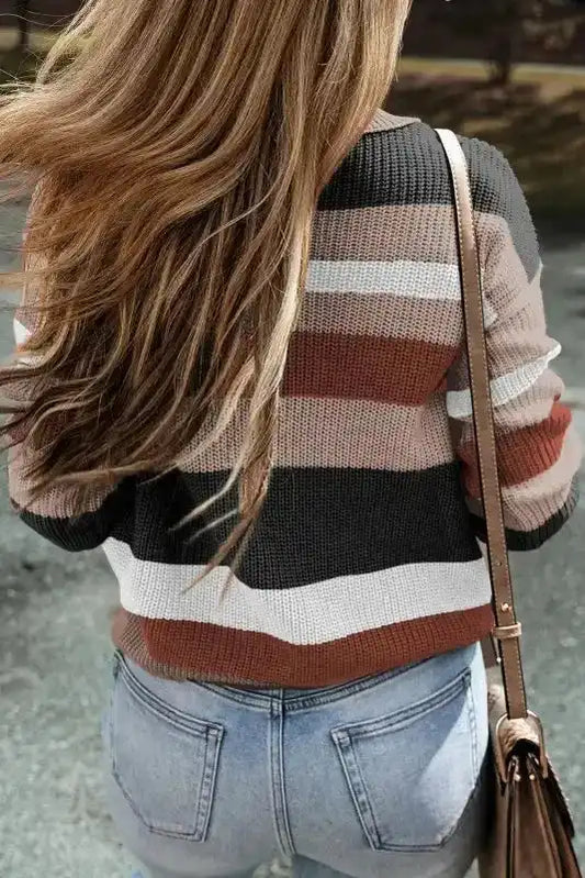 Back view of taupe colorblock knit sweater showing horizontal stripes and textured knit, ideal for casual daily wear in cooler seasons.