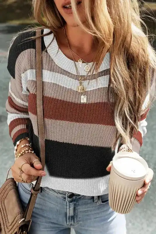 Taupe knit sweater with colorblock stripes in black, brown, and white tones, featuring a round neck and casual fit for women’s fall fashion.