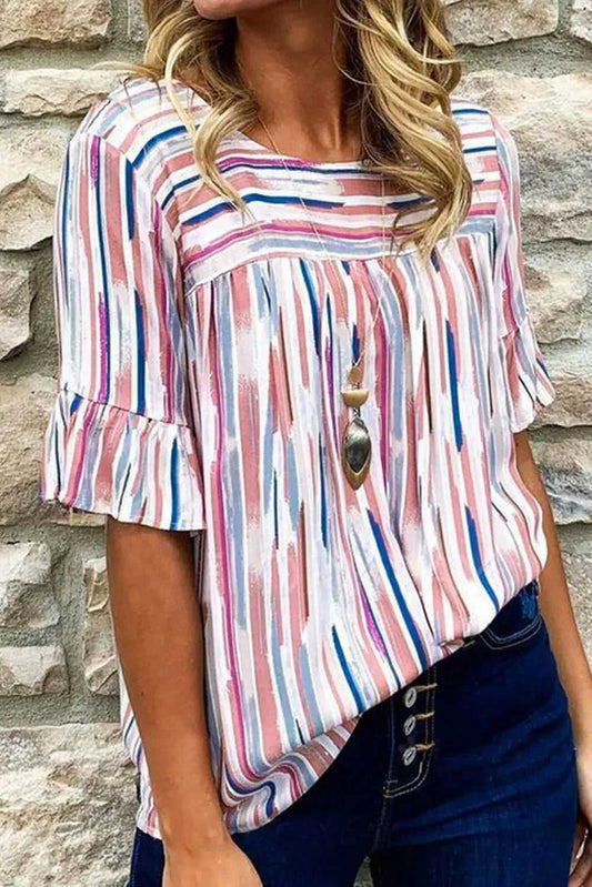 Vibrant Rainbow Stripe Splash Blouse with half sleeves and ruffle cuffs, styled casually with dark denim jeans for a chic summer look.