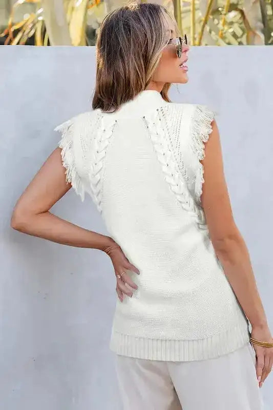 Back view of white tasseled woven knit tank top featuring braided knit details and fringe trim, ideal for casual summer outfits.