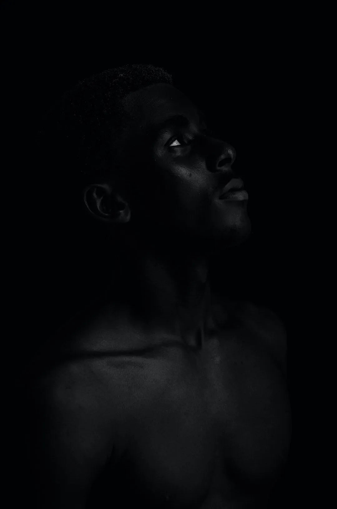 A contemplative portrait of a person against a dark background, inspired by the evolution of Victorian Corsets