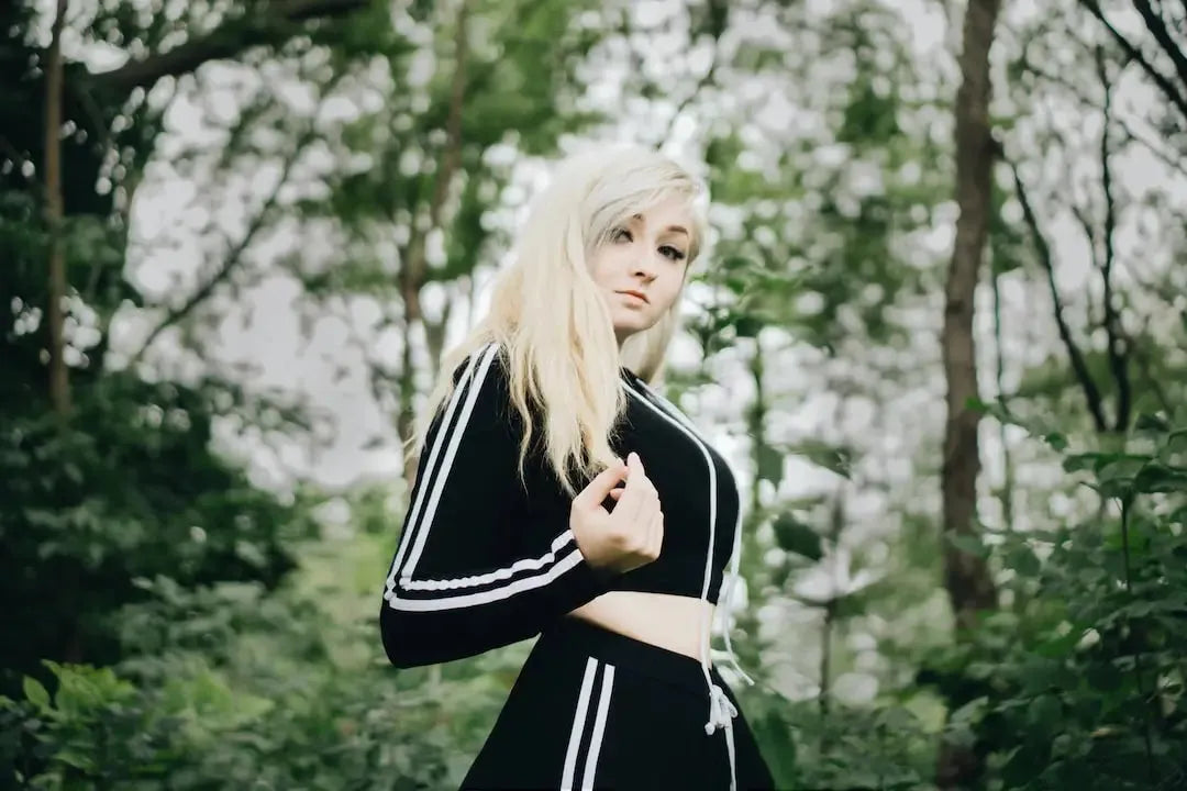 Model in a stylish black casual jumpsuits set against a natural green background
