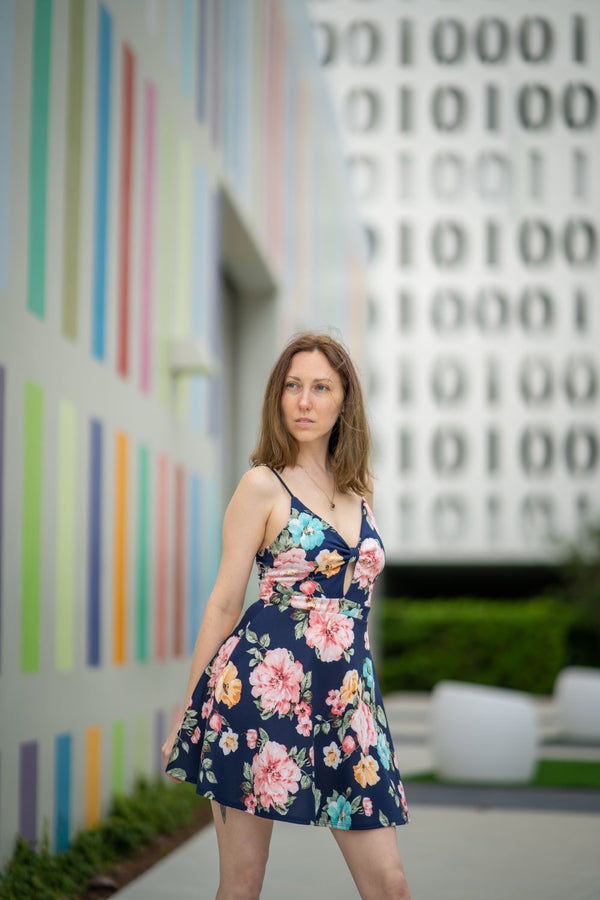 Woman in tropical print floral dress colourful wall UK 2026