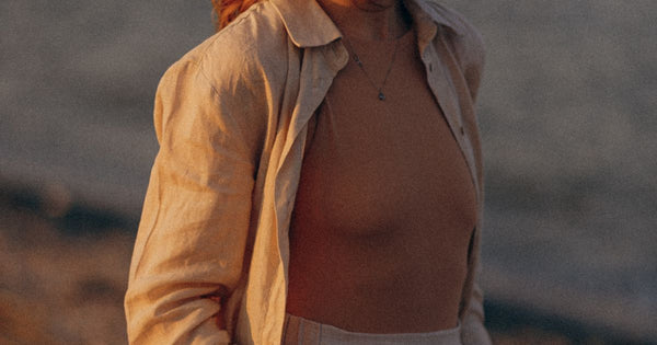 Woman in casual summer outfit enjoying beach sunset - Ibiza holiday wardrobe 2026