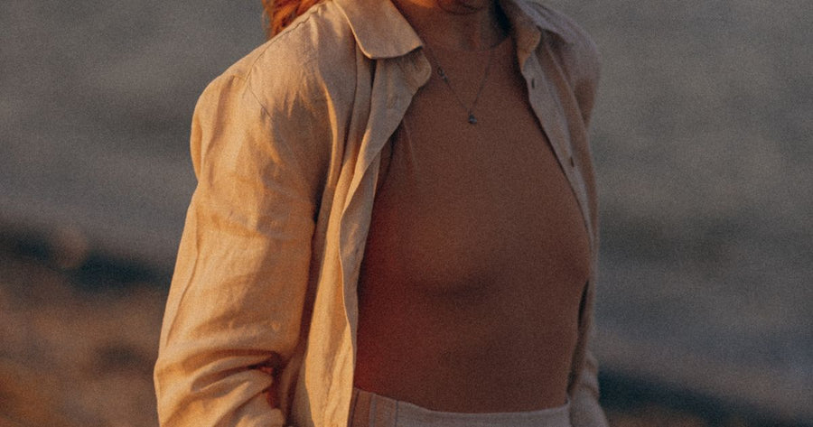Woman in casual summer outfit enjoying beach sunset - Ibiza holiday wardrobe 2026