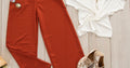 Modern summer outfit flatlay with red trousers and white top - late July style reset 2026