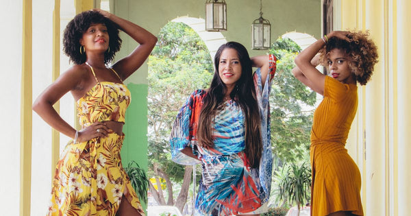 Three women in elegant floral dresses posing outdoors - UK garden party outfit 2026