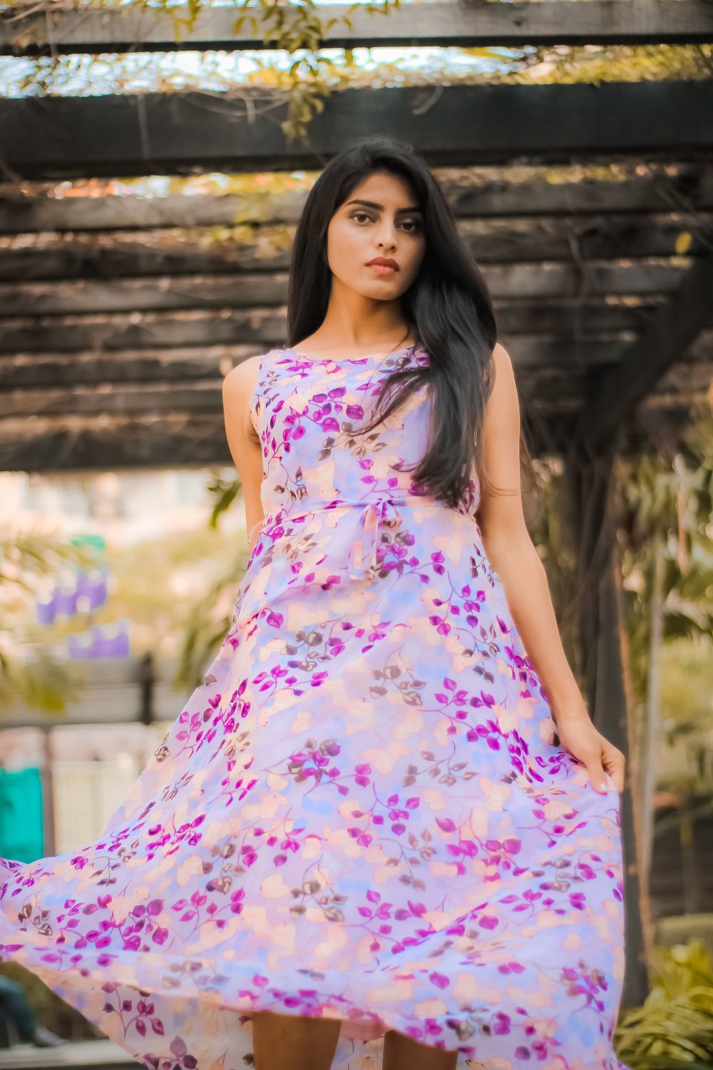 Elegant woman in pink floral dress garden setting summer 2026