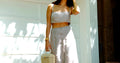Woman in white spaghetti strap dress with sunglasses - summer wedding guest outfits 2026