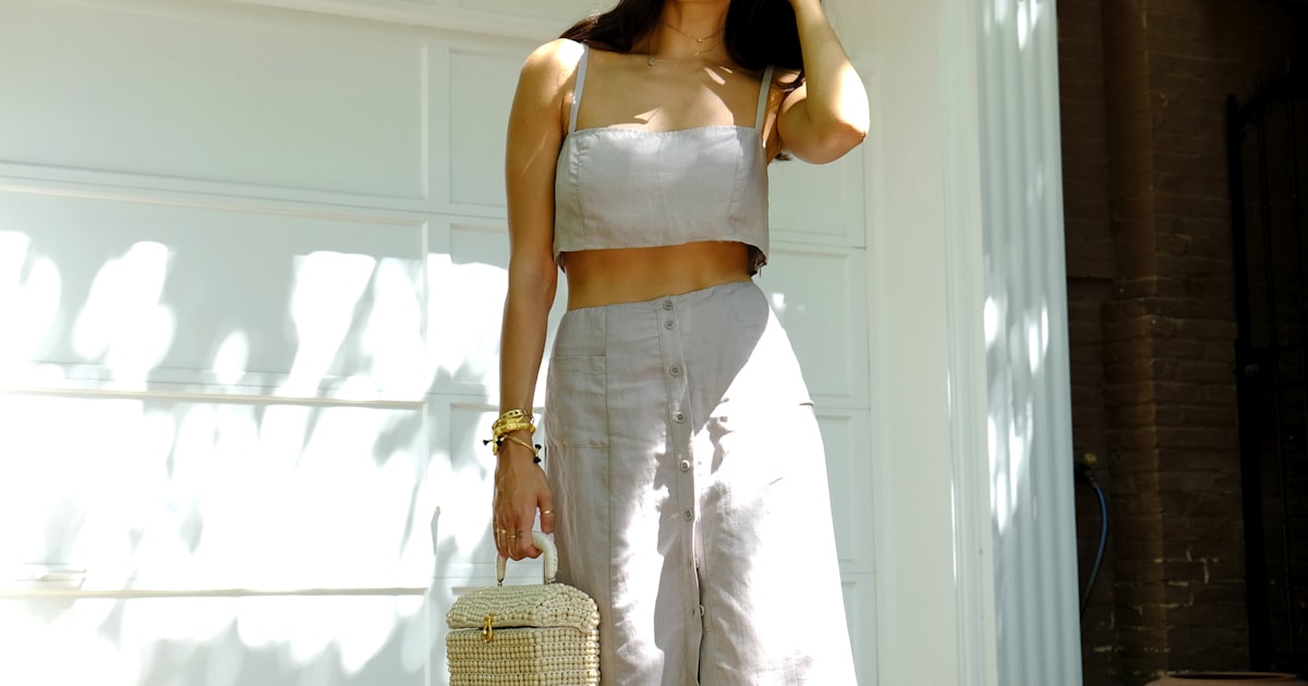 Woman in white spaghetti strap dress with sunglasses - summer wedding guest outfits 2026