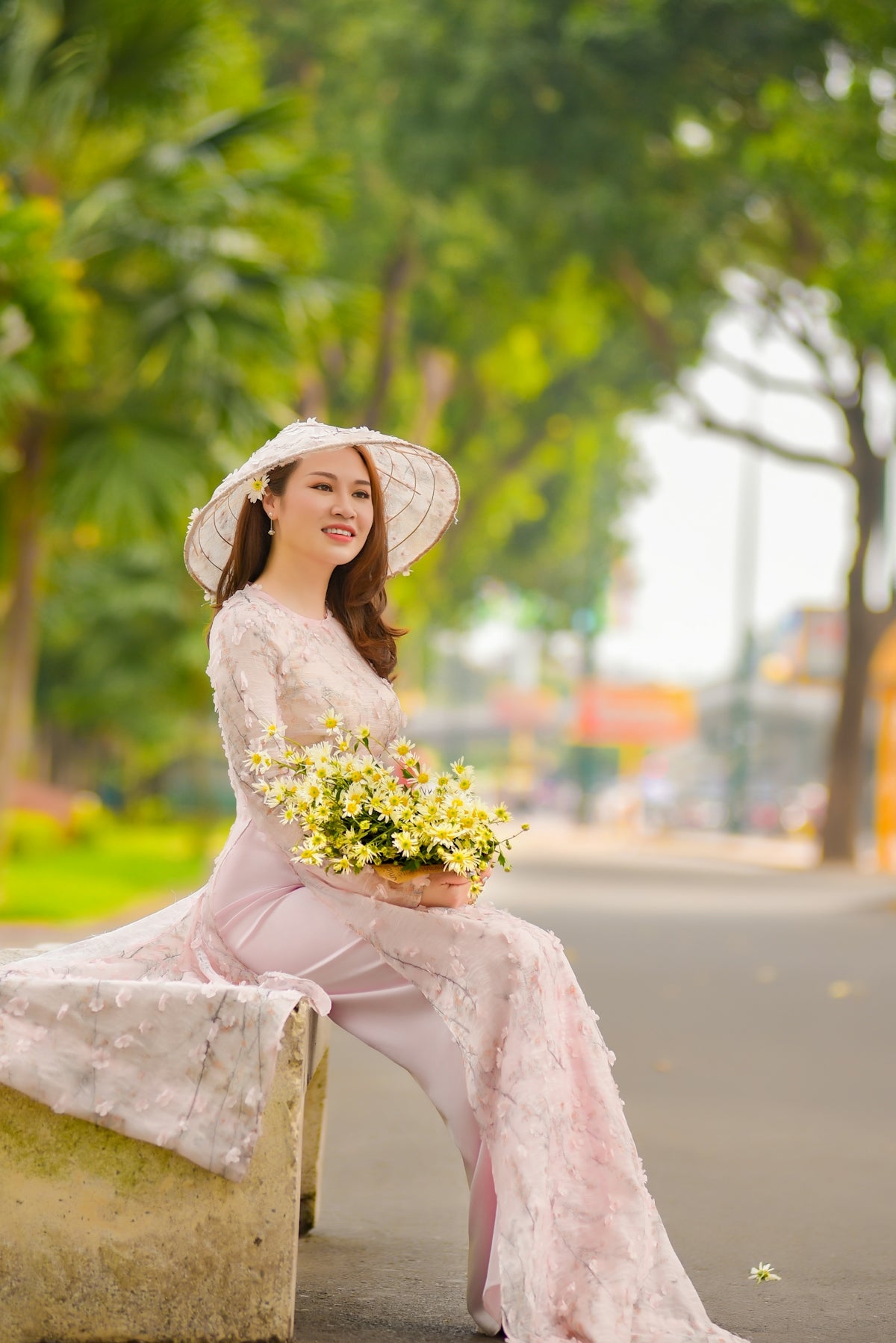woman in pink dress holding bouquet of flowers