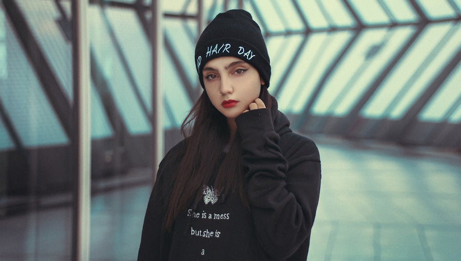 woman in black knit cap and black jacket