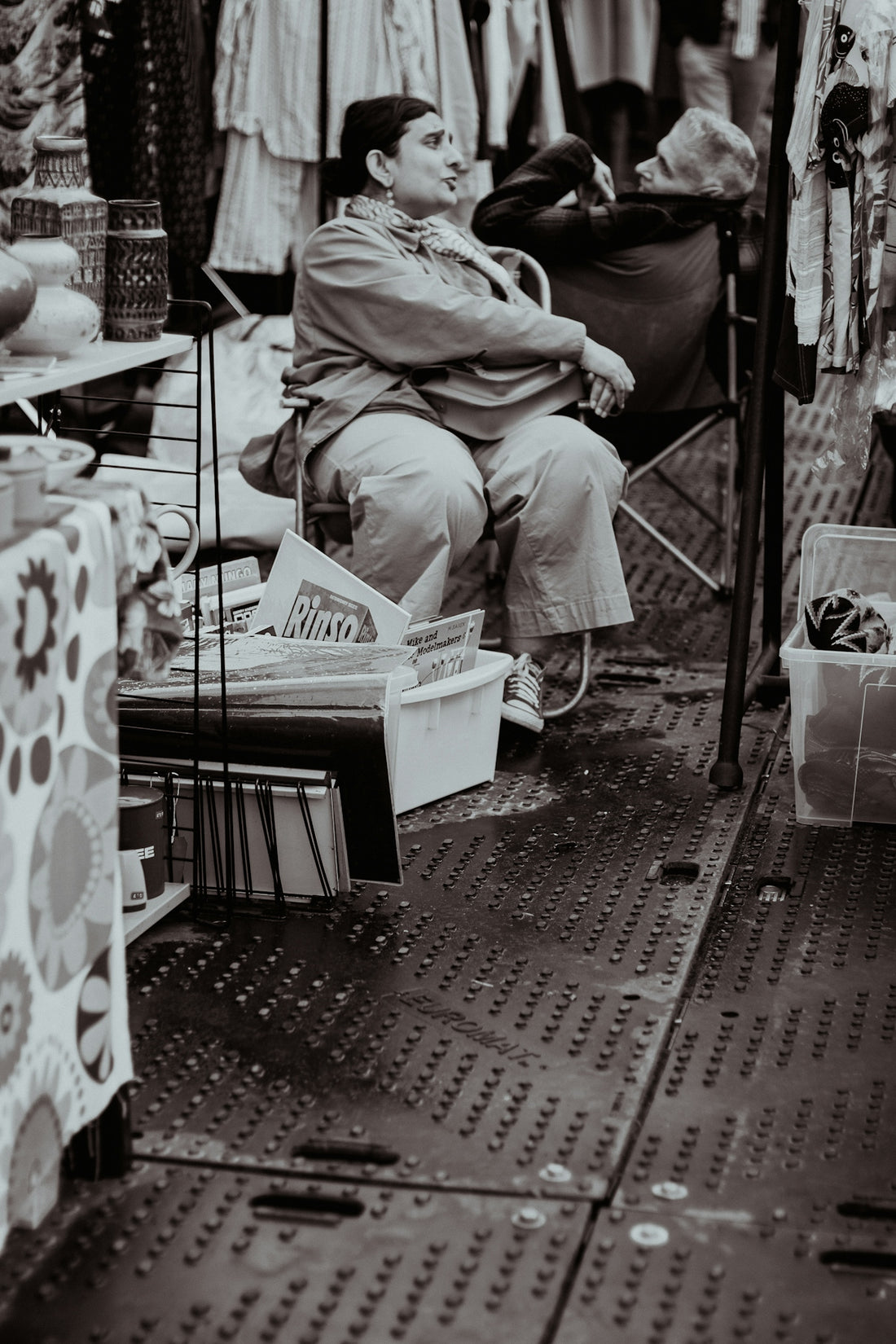 a man sitting on a chair in front of a store
