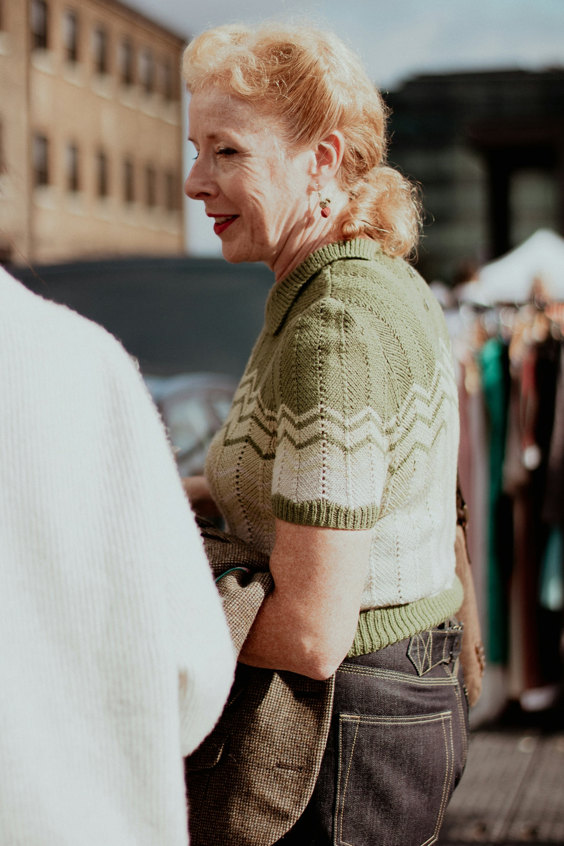 a woman standing next to a man on a street
