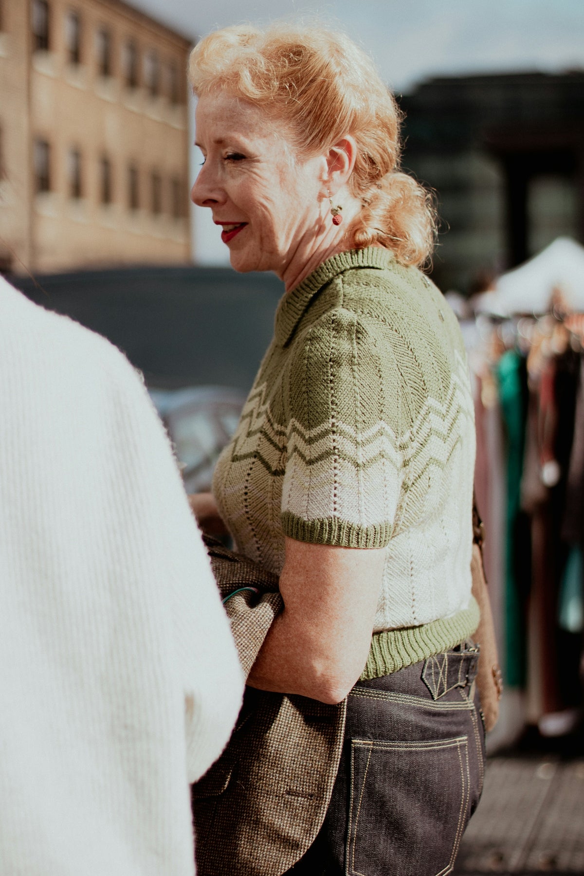 a woman standing next to a man on a street