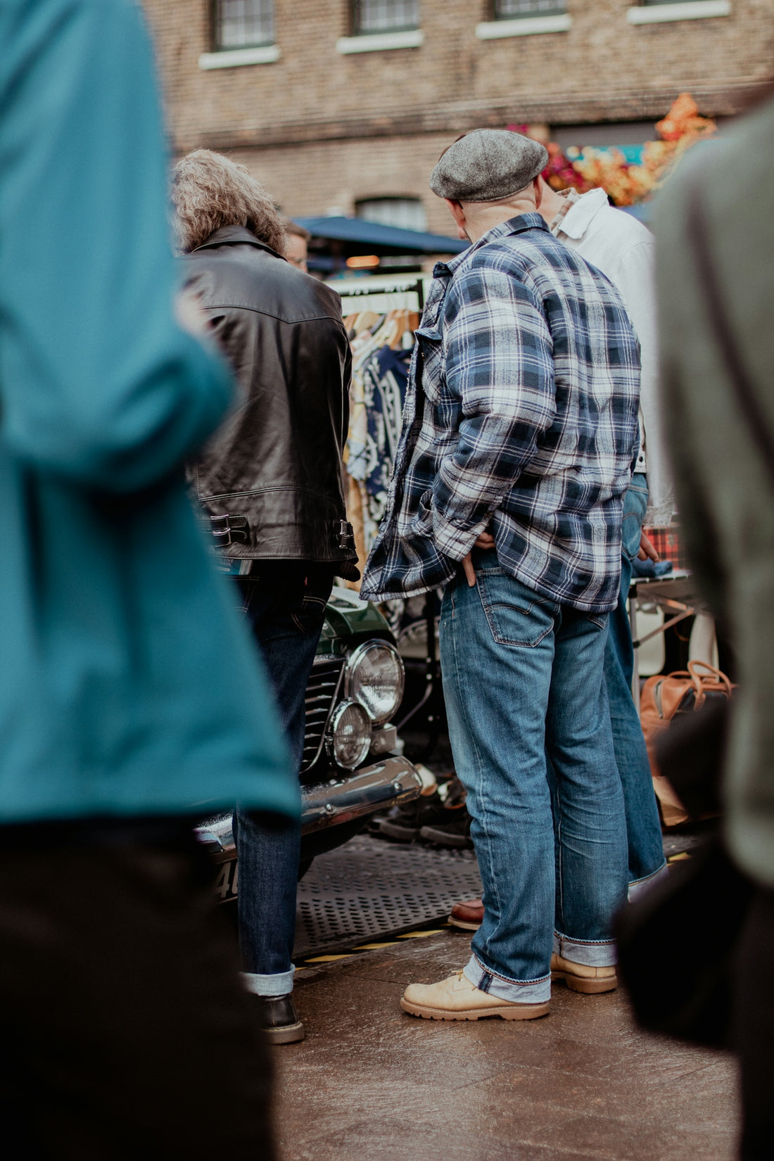 a group of people standing around a motorcycle