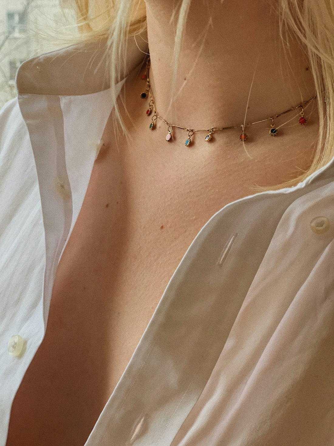 a close up of a woman wearing a necklace