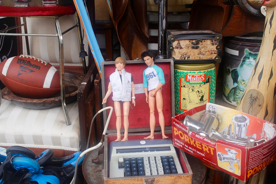 a couple of dolls standing on top of a scale