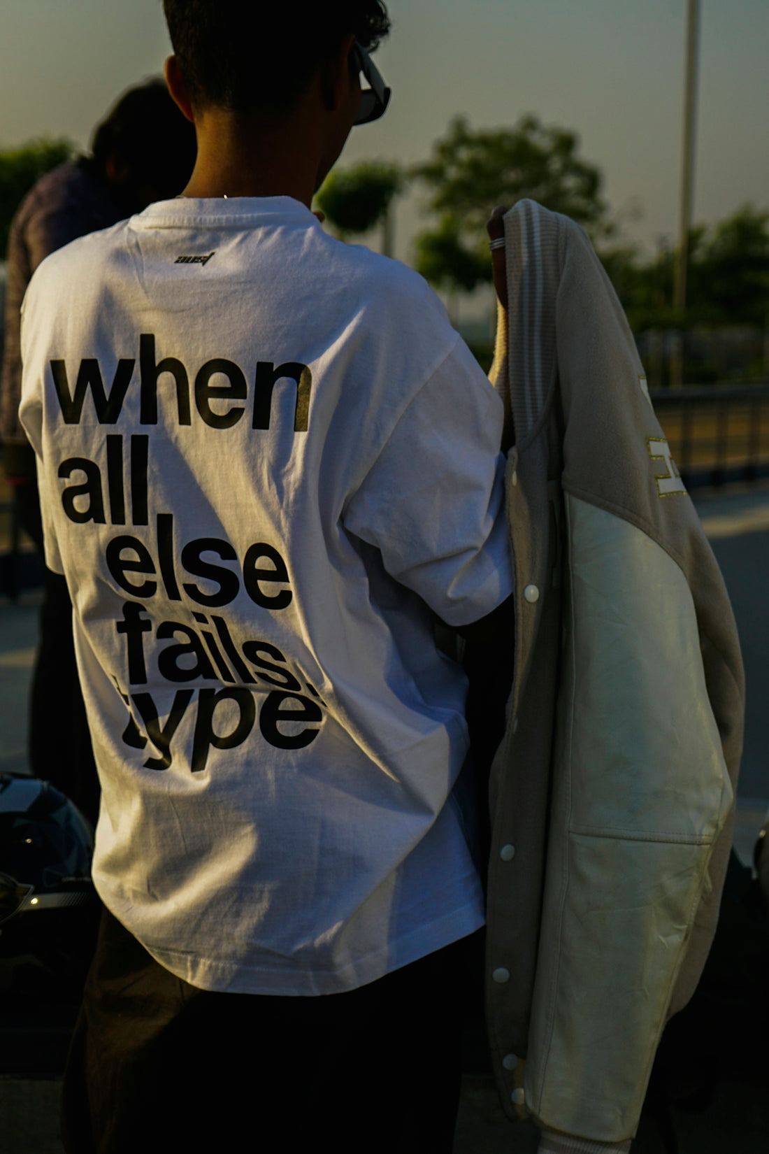 a man with a white t - shirt that says when all else talks vote